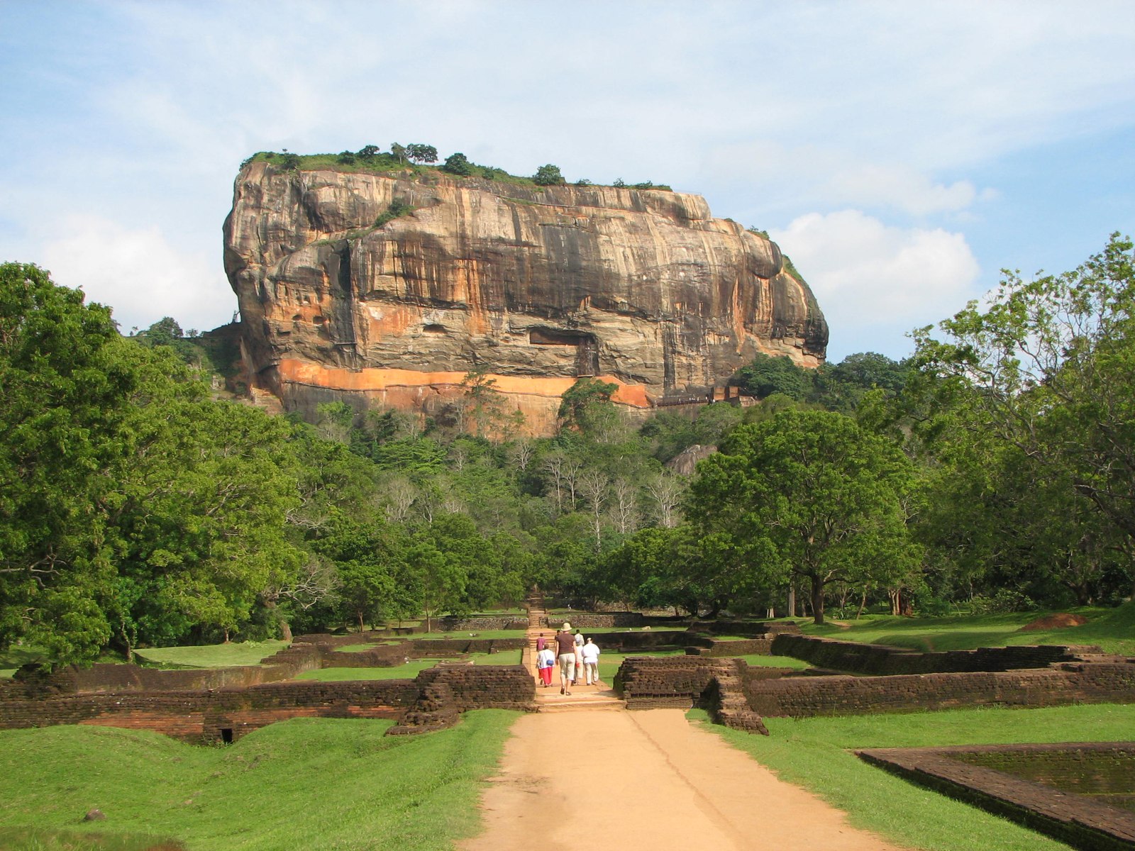 Sigiriya Rock rising above lush tropical forest
